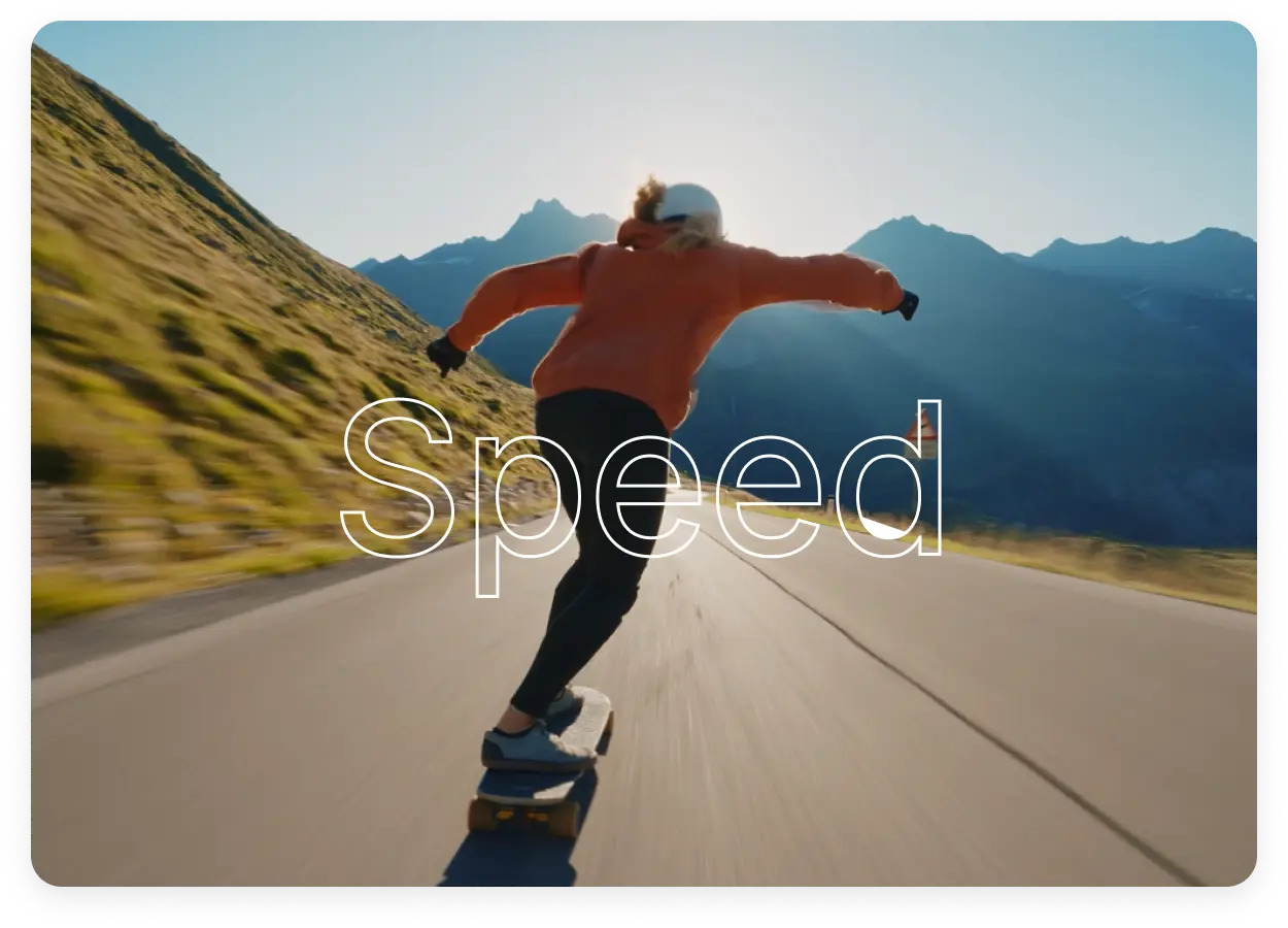 Man skateboarding down a mountainside road with a scenic backdrop of mountains.